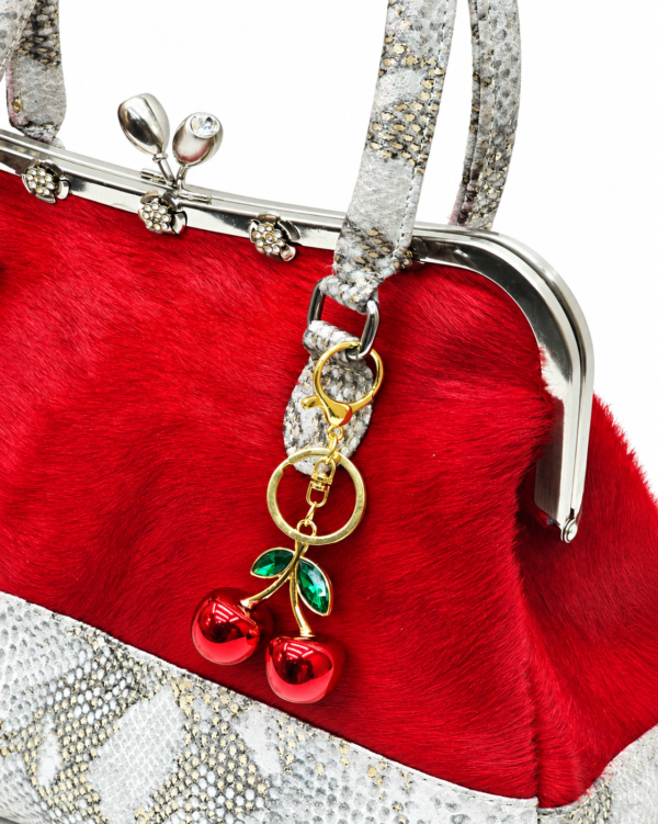 Sísí Èkó Àrà Scarlet Silver close-up showing scarlet red hair-on-hide leather, silver-tone frame and optional bag charm sold separately