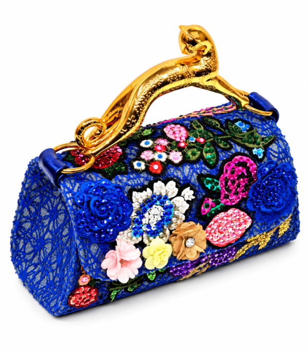 Corvane MAJESTA 6241 top handle bag, front-side angled view showing blue jacquard lace, dimensional floral embellishment and gold-tone leopard handle