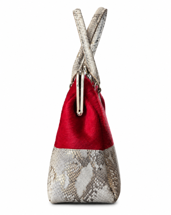 Sísí Èkó Àrà Scarlet Silver handbag, side view showing scarlet red hair-on-hide upper body and silver and white python-print leather lower section