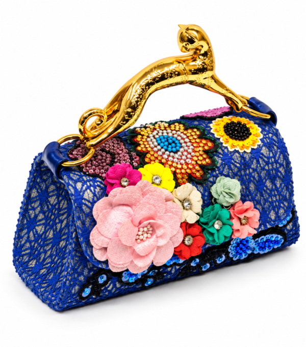 Corvane MAJESTA 7358 top handle bag, front-side angled view showing blue jacquard lace, dimensional floral embellishment and gold-tone leopard handle