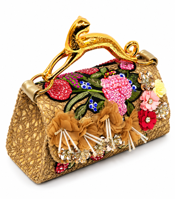 ALT Text: Corvane MAJESTA 8426 top handle bag, front-side angled view showing tan-beige jacquard lace, dimensional botanical embellishment and gold-tone leopard handle