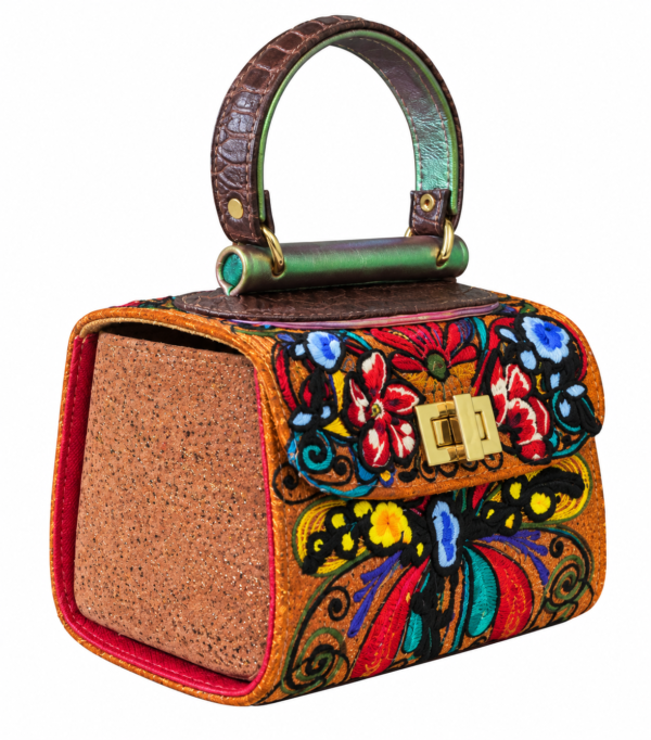 HelaSol Roidery Midi 4387 handbag, front-side angled view showing multicolour floral and butterfly Roidery with warm tan side leather and gold-tone fittings