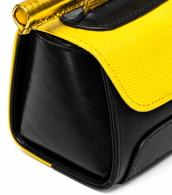 HelaSol AL Chōnmun MM Noir Soleil close-up showing black leather side panel, vivid yellow textured leather flap and gold handlebar detailing.