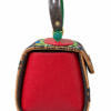 HelaSol Roidery Midi 5816 handbag, side view showing rich red textured leather panel, deep brown top handle and green metallic handlebar detail
