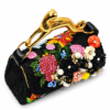 Corvane MAJESTA 8147 top handle bag, front-side angled view showing black jacquard lace, dimensional floral embellishment and sculptural gold-tone leopard handle