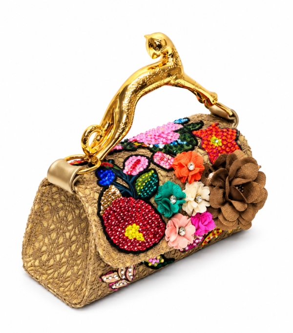 Corvane MAJESTA 5632 top handle bag, front-side angled view showing tan-beige jacquard lace, layered embellishment and gold-tone leopard handle