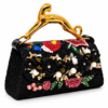 Corvane MAJESTA 9583 top handle bag, front-side angled view showing black jacquard lace, red and black floral embellishment and gold-tone leopard handle