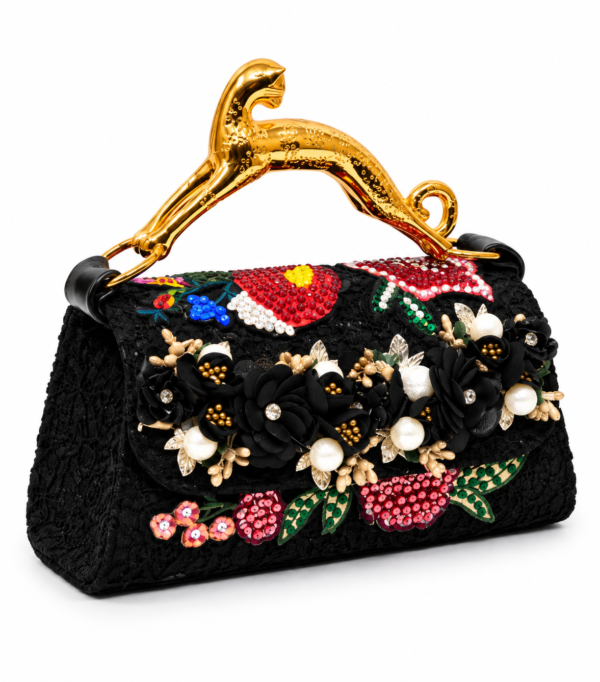 Corvane MAJESTA 9583 top handle bag, front-side angled view showing black jacquard lace, red and black floral embellishment and gold-tone leopard handle