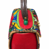 HelaSol Roidery Midi 5816 handbag, top angle view showing red textured leather side panel, green metallic handlebar detail, deep brown top handle and multicolour Roidery across the upper body.